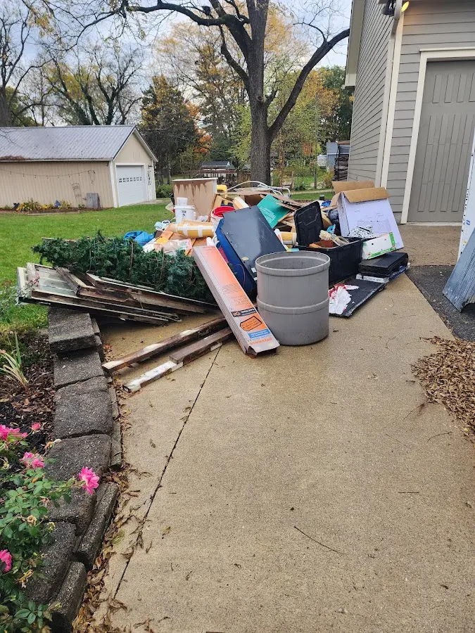 Dumpster being loaded with debris for Estate Cleanout Dumpster Rental in Elmwood